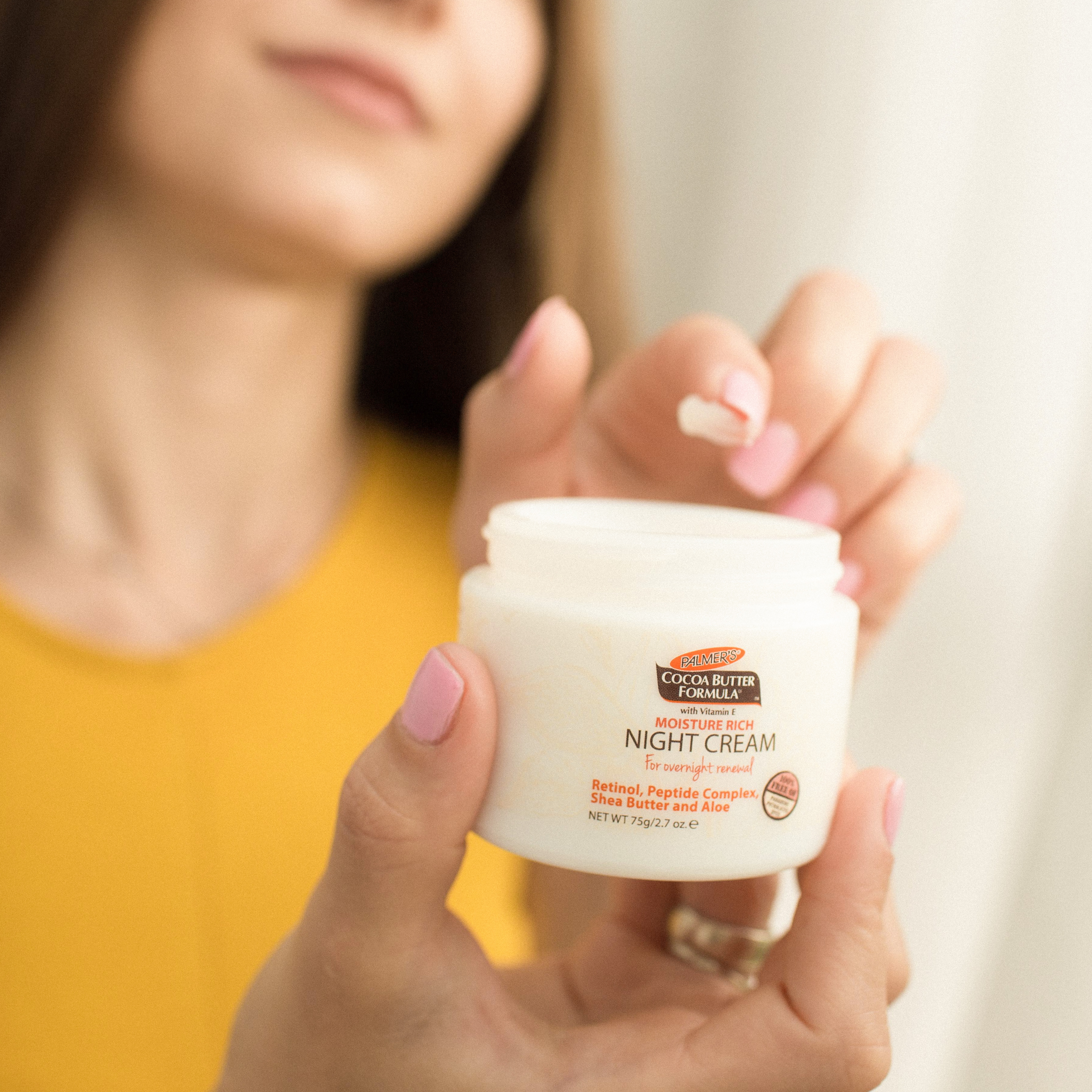 Palmer's Cocoa Butter Formula Moisture Rich Night Cream, a retinol night cream, in hand