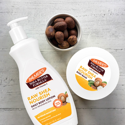 Palmer's Shea Butter Formula Shea Nourish Body Lotion and Body Balm, one of the best moisturizers for all skin types, on a wooden table with shea nuts