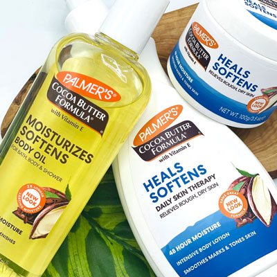 Palmer's Cocoa Butter Formula Moisturizing Body Oil, Body Lotion and Original Solid Jar on a table