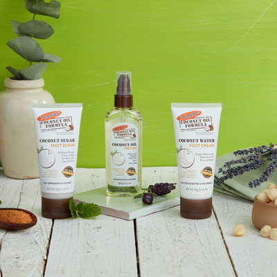Palmer's Coconut Oil Formula Foot Care, ideal for your fall skin care routine, on a table with ingredients