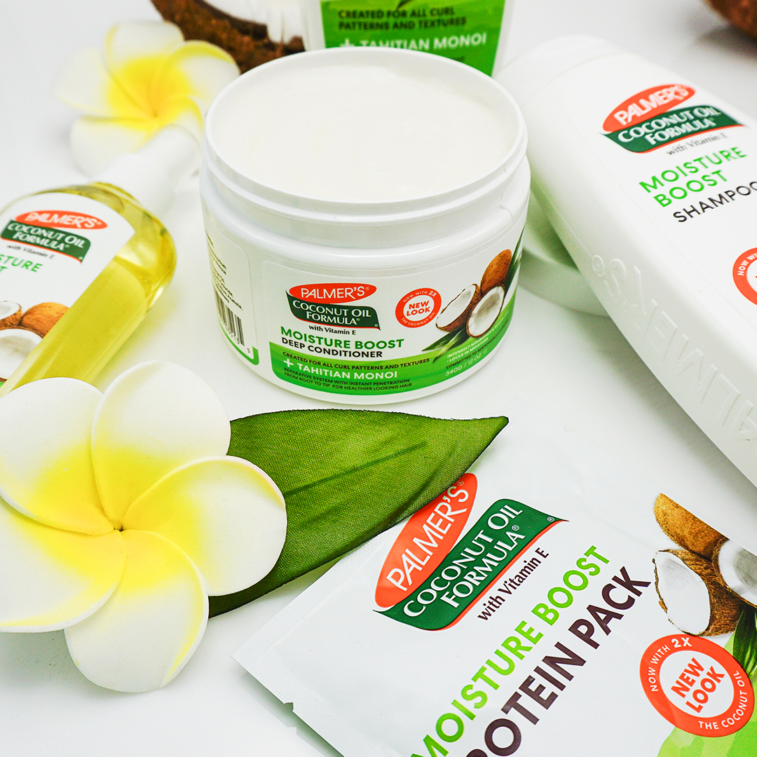 Palmer's Coconut Oil Formula Deep Conditioner and Protein Pack - perfect for caring for wavy hair on table with coconuts