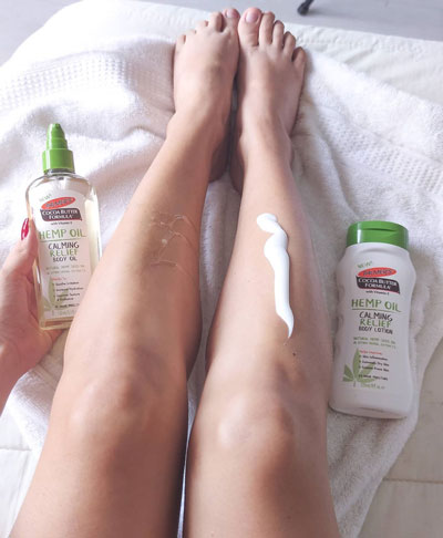 Palmer's Hemp Oil Calming Relief Body Lotion and Body Oil for moisturizing dry skin during winter being applied to legs