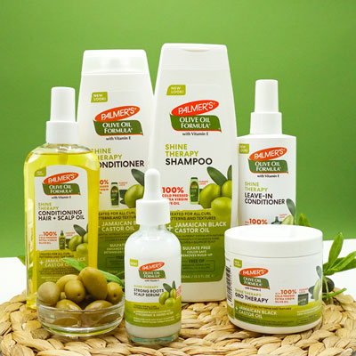 Palmer's Olive Oil Formula Shine Therapy collection has all the olive oil and Jamaican black castor oil benefits for hair on table with olives