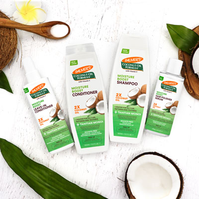 Palmer's Coconut Oil Moisture Boost collection, with the sulfate free shampoo, on table with ingredients