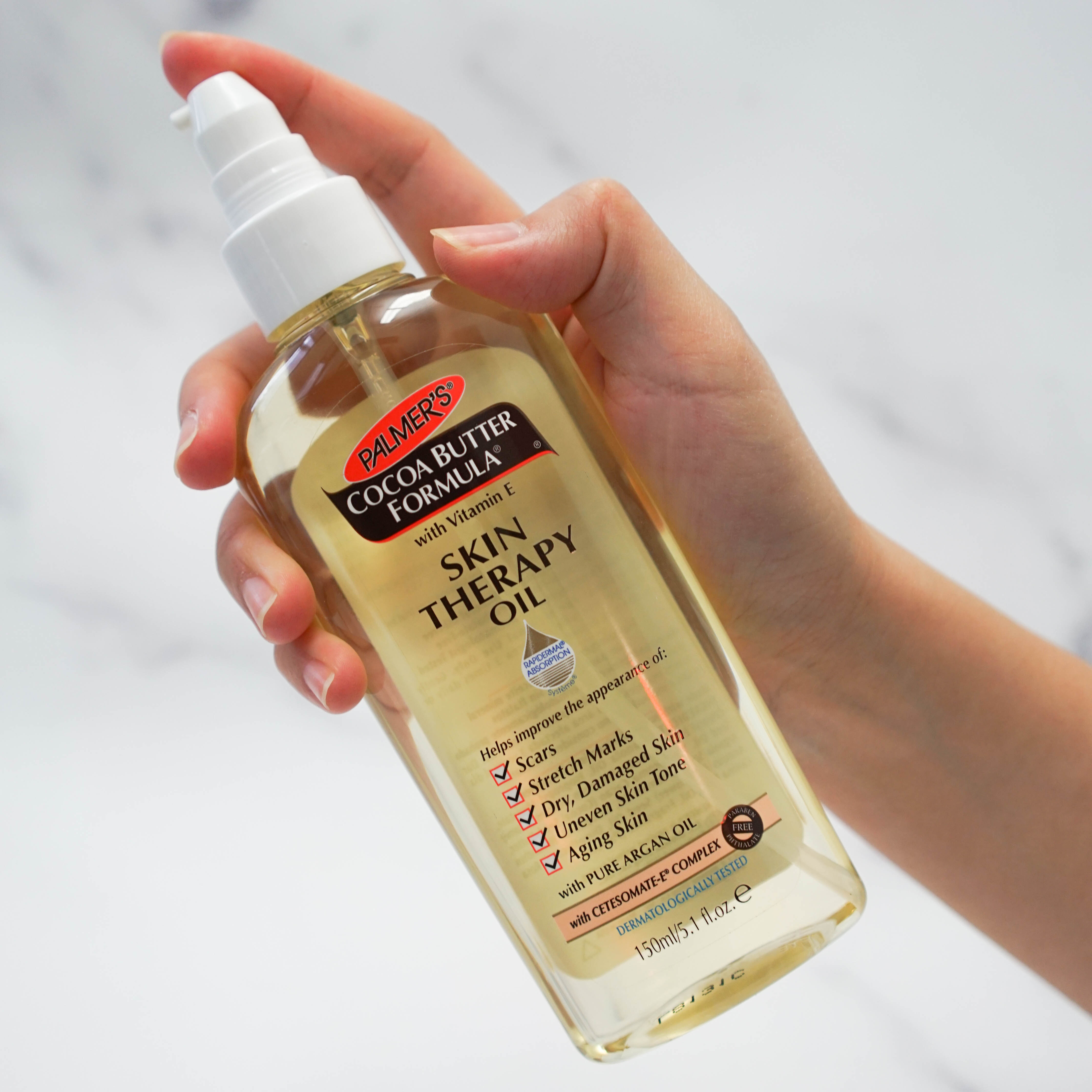Palmer's Cocoa Butter Formula Skin Therapy Oil in hand