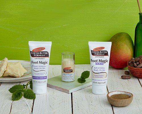 Palmer's Cocoa Butter Formula Foot Care for winter foot care on table with ingredients