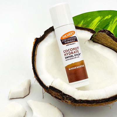 Palmer's Coconut Hydrate Swivel Stick, a winter lip care staple, in a broken open coconut