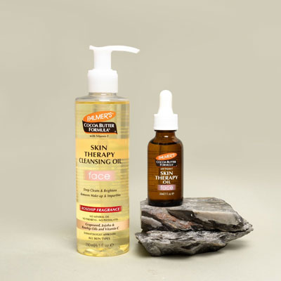The best face oil for dry skin, Palmer's Skin Therapy Face Oil and Cleansing Oil on beige background with oil on rocks