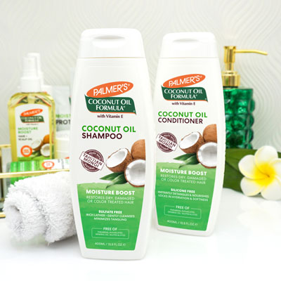 Ideal for cleansing box braids with curls, Palmer's Coconut Oil Shampoo and Conditioner on vanity 