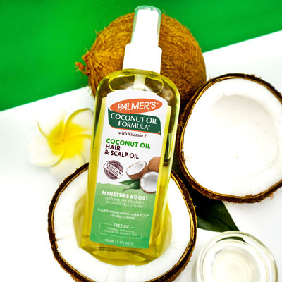 Palmer's Coconut Oil for Hair & Scalp in a coconut with a green background