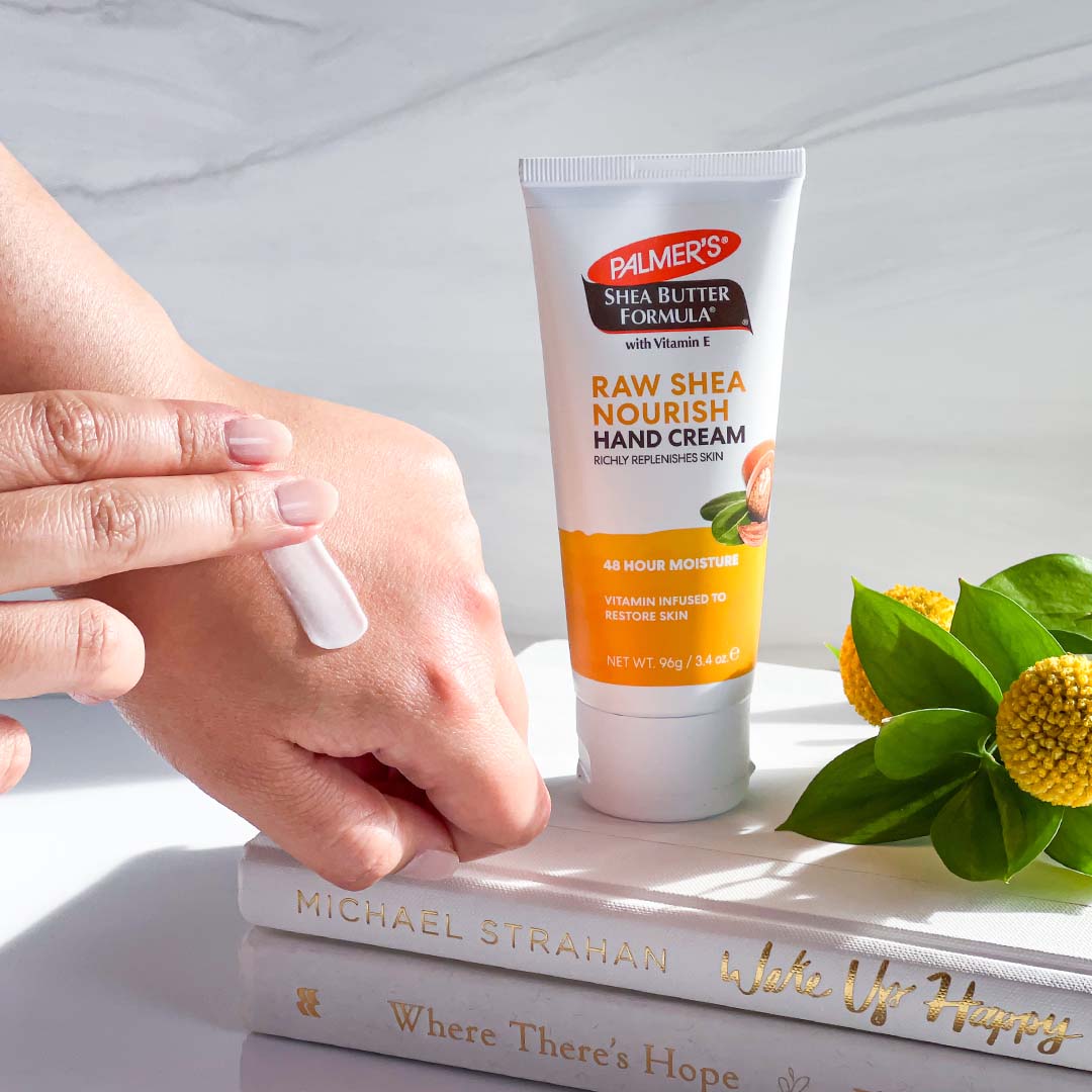 Palmer's Shea Butter Formula Hand Cream for helping to heal super dry hands in winter being applied to hands 