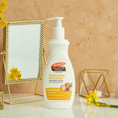 Palmer's Shea Butter Lotion to protect skin from wind on vanity with mirror and flowers