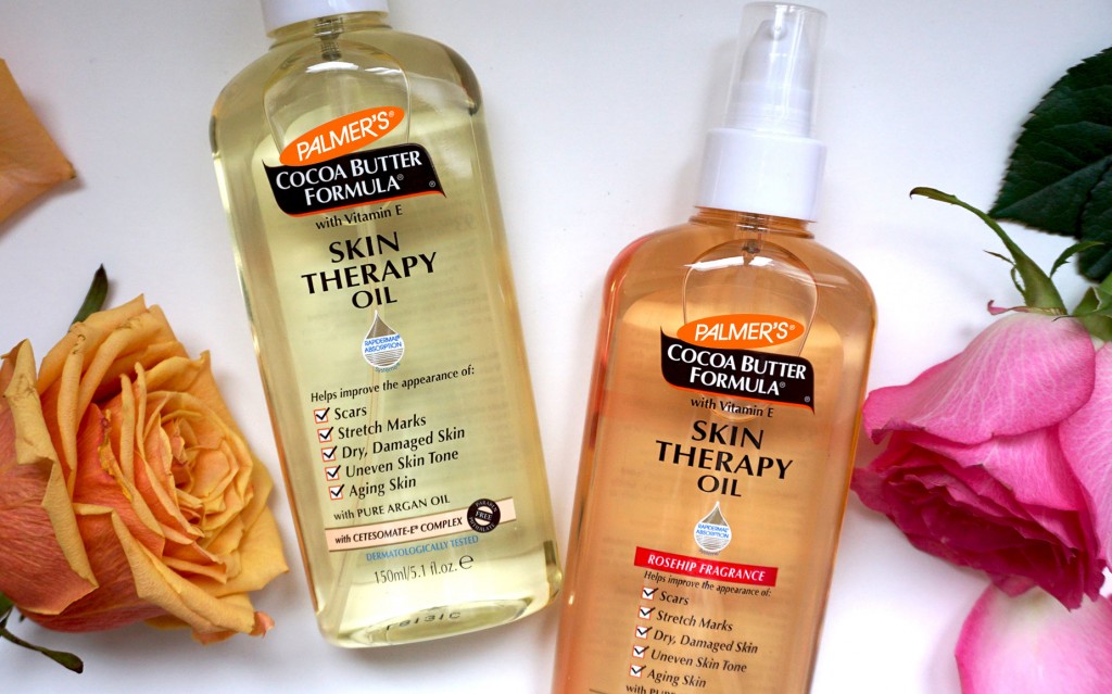 Palmer's Skin Therapy Oil and Skin Therapy Oil Rosehip, the best skincare for uneven skin tone, on table with flowers