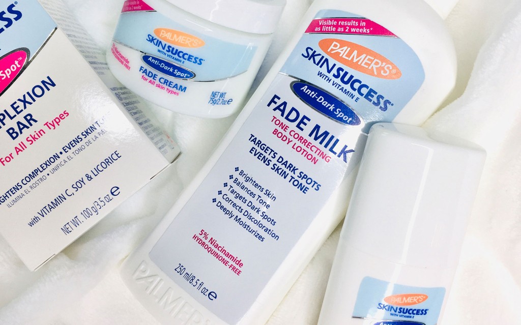 Palmer's Skin Success Fade Milk and Fade Cream, top skincare products recommended by dermatologists, on a white blanket