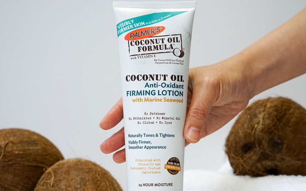 Palmer's Coconut Oil Formula Anti-Oxidant Firming Lotion being picked up from table