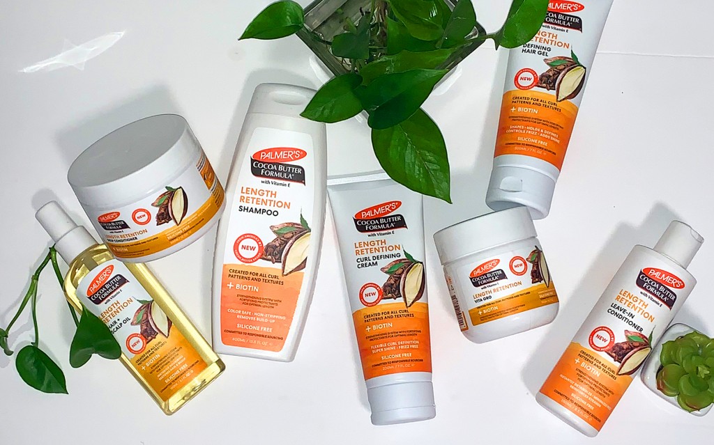 Palmer's Cocoa Butter Formula Length Retention products, ideal for all hair porosity levels, on a white table with plants