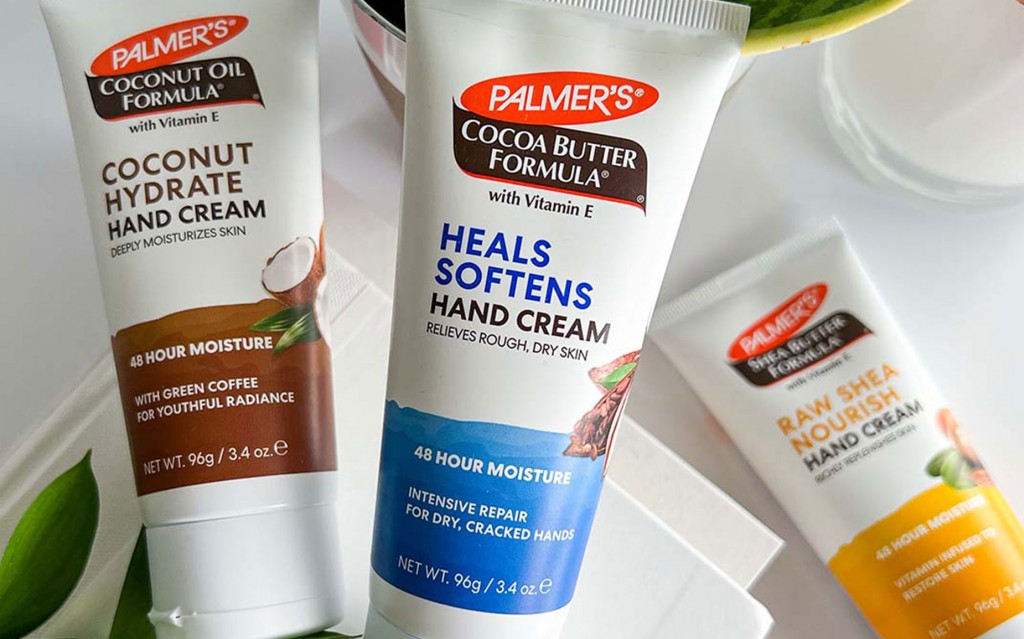 Palmer's Hand Cream collection for helping to heal super dry hands in the winter on a table with books