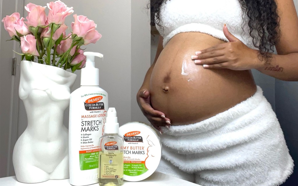 Black woman applying Palmer's Massage Lotion during her third trimester self care routine