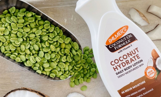 Palmer's Coconut Oil Formula Body Lotion with the effects of green coffee extract on skin on table with green coffee beans