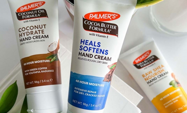 Palmer's Hand Cream collection for helping to heal super dry hands in the winter on a table with books