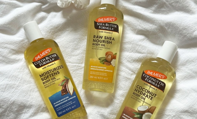 Palmer's Body Oils for Glowing Skin on white fabric background