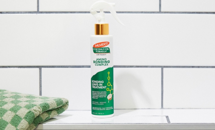 Palmer's Amino Bonding Complex Leave In Treatment for hair on tiled shower shelf with towel 