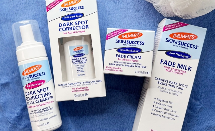 Palmer's Skin Success Anti-Dark Spot collection with niacinamide for acne scars on a towel