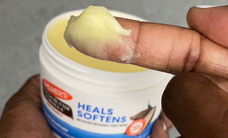 Palmer's Cocoa Butter Formula Original Solid Jar on woman's finger during her skin slugging routine
