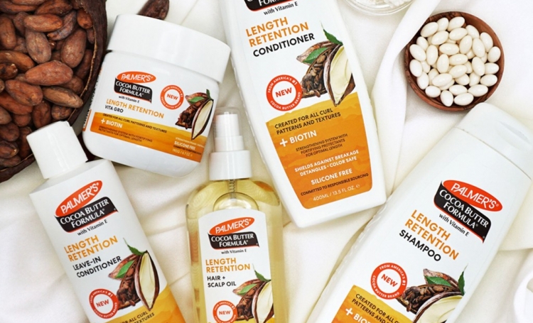 Palmer's Cocoa Butter Formula Length Retention collection on a blanket with ingredients