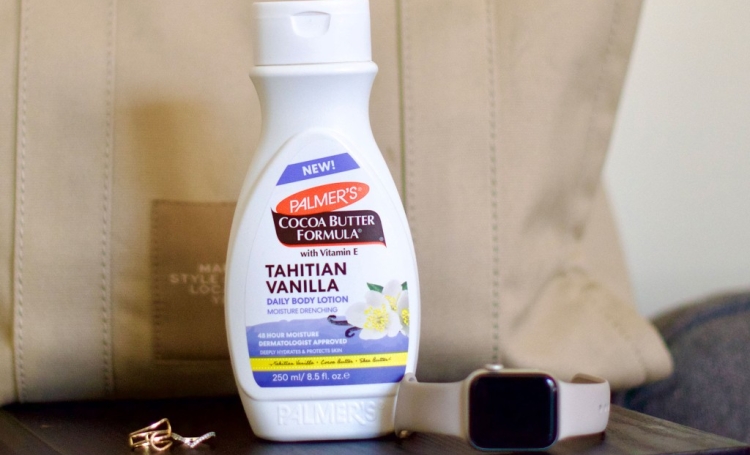 Palmer's Tahitian Vanilla Body Lotion on table with Apple Watch and Large Bag